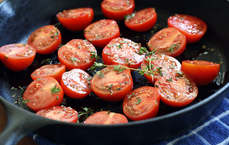 Tomatoes and thyme in a cast iron skillet